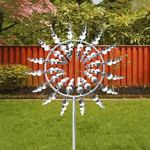 Sherem Magical Metal Windmill in garden with fence